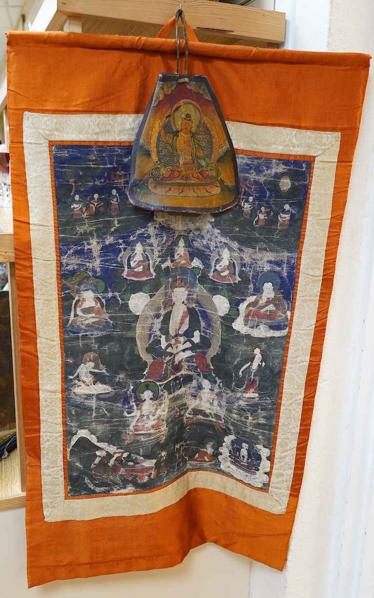 A Tibetan painted silk thangka and another painted on an ox bone, both 19th century. Condition - poor to fair